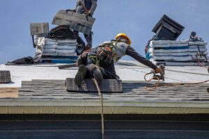 Roofing materials displayed beside a residential roof with metal panels, slate tiles, and asphalt shingles.